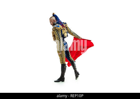 Torero in blue and gold suit or typical spanish bullfighter isolated over white studio background. The taming, achieving the goal, mortification, conquest, boss, leadership, battle, win, winner concept Stock Photo