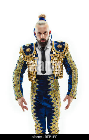 Torero in blue and gold suit or typical spanish bullfighter isolated over white studio background. The taming, achieving the goal, mortification, conquest, boss, leadership, battle, win, winner concept Stock Photo