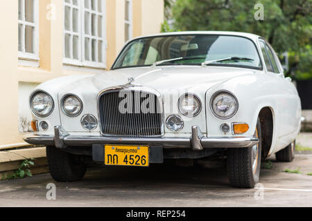 Vientiane, Laos - August 9, 2018: a white Jaguar Mark X with a Laotian vehicle registration plate parked in the street. Stock Photo