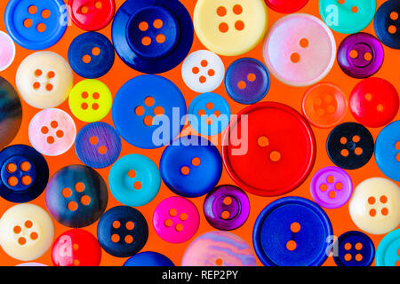 Collection of various sewing buttons on a red background Stock Photo