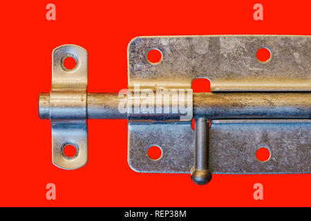 Steel door bolt, isolated on a red background Stock Photo