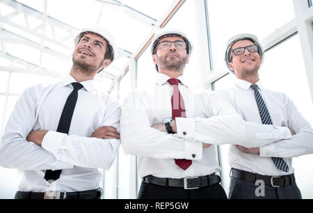 three architects standing in an empty office Stock Photo