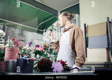 Concentrated stylish gardener being deep in his thoughts Stock Photo