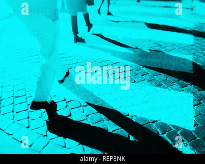 Blurry city zebra crossing with walking pedestrians legs making long shadows. Duotone effect with texture Stock Photo