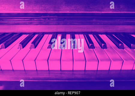 close-up view of the keys of a ancient ruined piano. Purple duotone effect Stock Photo