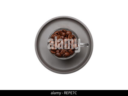Coffee beans in a glass cup with sauser, isolated cutout on white color background, top view Stock Photo