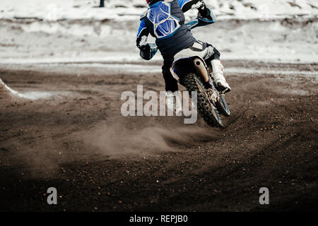 motorcycle racer enduro motocross riding on winter track Stock Photo