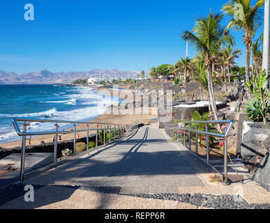 Puerto del Carmen beach in Lanzarote, Canary islands, Spain. blue sea, palm trees, selective focus Stock Photo