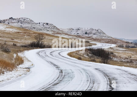 Scenic Loop Road curving through the snowy badlands in November, South Unit of Theodore Roosevelt National Park, North Dakota, USA Stock Photo