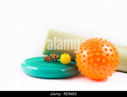 Massage yourself, composition of different tools isolated on white. Self-deep tissue massage concept. Spiky ball, foam roller, wooden roll, half balan Stock Photo