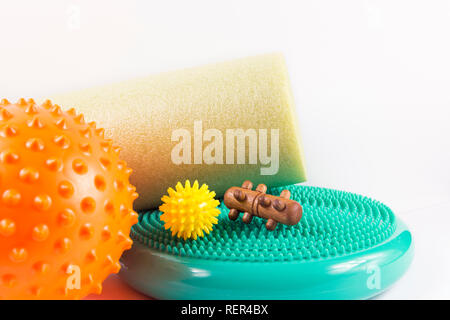 Massage yourself, composition of different tools isolated on white. Self-deep tissue massage concept. Spiky ball, foam roller, wooden roll, half balan Stock Photo