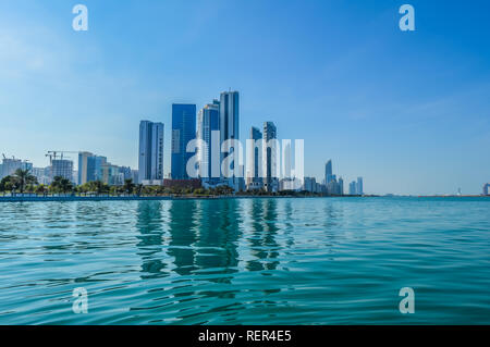 Abu Dhabi city skyline along Corniche beach taken from a boat in UAE Stock Photo