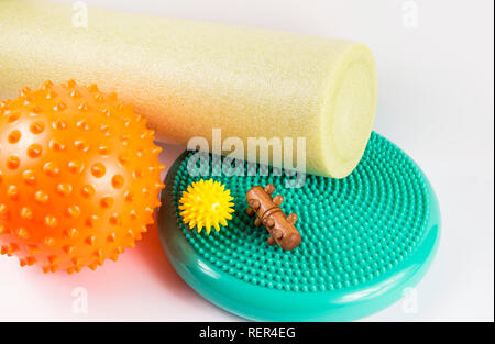 Massage yourself, composition of different tools isolated on white. Self-deep tissue massage concept. Spiky ball, foam roller, wooden roll, half balan Stock Photo