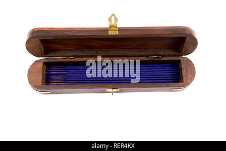 Wooden opened incense holder box with storage case, incense sticks candles inside, isolated on white. Stock Photo