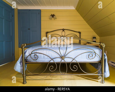 Double bed with antique brass headboard and footboard plus pine