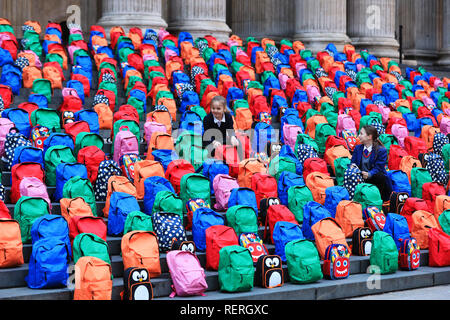 London, UK. 23rd Jan 2019. School children Joana, 9, and sister Jessica, 11, from London look at the 800 schoolbags laid by WaterAid on the steps of St Paul's Cathedral in a moving tribute to the number of children who die every day from dirty water, never reaching their fifth birthday or first day at school. WaterAid placed 800 children's schoolbags on the famous steps of St Paul's Cathedral today as a stark reminder of the number of young children's lives lost every single day due to dirty water and poor sanitation. Credit: Oliver Dixon/Alamy Live News Stock Photo