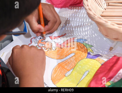 Wellington, New Zealand. 23rd Jan, 2019. A 7-year-old boy Liam colors a Chinese dragon in Te Papa, the national museum of New Zealand in Wellington, New Zealand, Jan. 23, 2019. A family event, with a theme on 'Painting and Decorating Chinese Dragons and Terracotta Warriors' was held on Wednesday to let local kids embrace Chinese ancient culture. Hundreds of children enjoyed the event and showcased their works by parading around the museum. Credit: Guo Lei/Xinhua/Alamy Live News Stock Photo