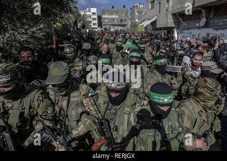 Bureij, Palestinian Territories. 23rd Jan, 2019. Masked armed members of Izz ad-Din al-Qassam Brigades, the military wing of the Hamas Palestinian Islamist organization, take part in the funeral of Hamas militant Mahmoud al-Nabahin, 24, after he was allegedly killed in Israeli strikes on the Gaza Strip a day earlier, hours after an Israeli officer was lightly wounded by Palestinian gunfire. Credit: Mohammed Talatene/dpa/Alamy Live News Stock Photo