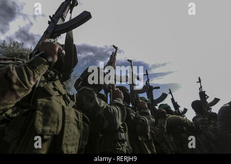 Bureij, Palestinian Territories. 23rd Jan, 2019. Masked armed members of Izz ad-Din al-Qassam Brigades, the military wing of the Hamas Palestinian Islamist organization, take part in the funeral of Hamas militant Mahmoud al-Nabahin, 24, after he was allegedly killed in Israeli strikes on the Gaza Strip a day earlier, hours after an Israeli officer was lightly wounded by Palestinian gunfire. Credit: Mohammed Talatene/dpa/Alamy Live News Stock Photo