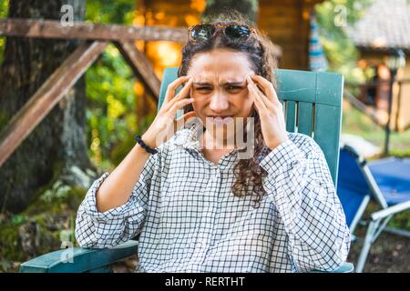 Young woman with headache, Italy Stock Photo