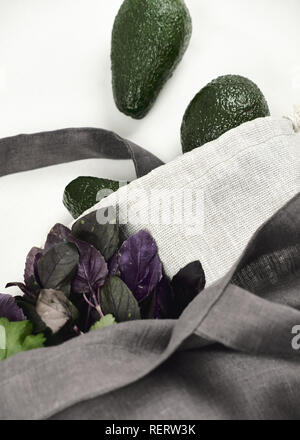 Gray Reusable Eco Friendly Bag with Avocado. Natural Zero Waste Linen or Cotton Sack for Keeping Local Green Vegetables Fresh and Healthy Isolated on  Stock Photo