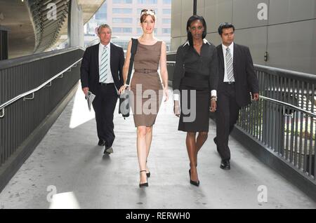 Group of business people walking through an urban passageway Stock Photo