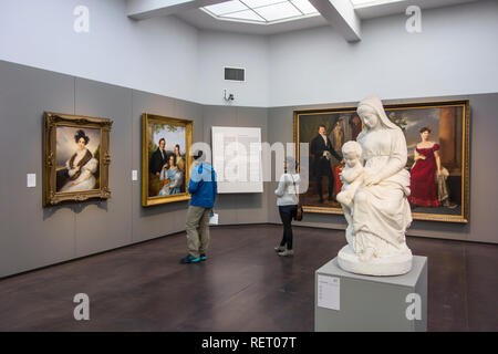 Visitors looking at 19th century Neoclassical paintings in the Groeningemuseum, Fine Arts Museum in the city Bruges, West Flanders, Belgium Stock Photo