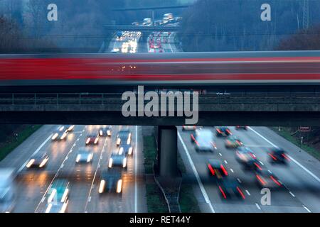 Local train, commuter train, crossing the A3 motorway near Mettmann, Erkrath, North Rhine-Westphalia Stock Photo