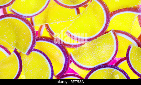 Decorative marmalade candy Background. Pattern of marmalade in shape of citrus fruits wedges. Jelly sweet candies. Food Texture. Beautiful Wide Angle  Stock Photo