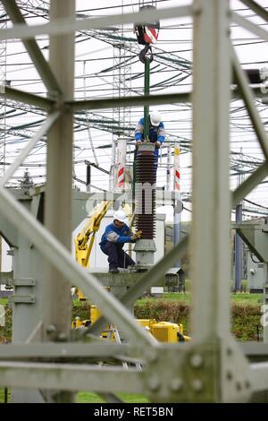 Workers doing maintenance work in a transformer station of the ELE, Emscher Lippe Energie GmbH, a subsiduary of RWE, Marl Stock Photo