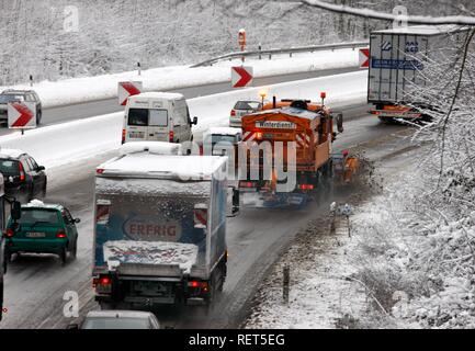 Snow plough in operation, traffic jam after heavy snow fall, motorway Autobahn A40, Ruhr expressway between Duisburg and Essen Stock Photo