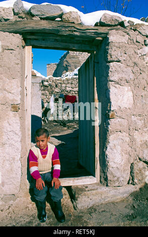 A young Turkish boy sitting on a doorstep at the village of Ihlara, Turkey Stock Photo