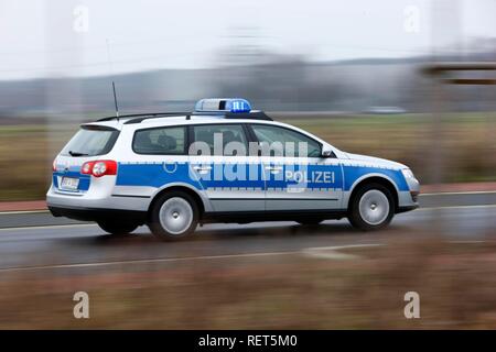 German police car, blue design, in action with flashing sirens Stock Photo