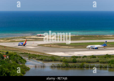 Montego Bay, Jamaica - March 27 2015: Southwest Airlines and Spirit Airlines aircraft taxiing on runway at Donald Sangster International (MBJ) Airport Stock Photo