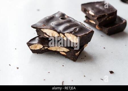 Bitter Almond Chocolate Pieces on White Marble Surface. Organic Snacks. Stock Photo