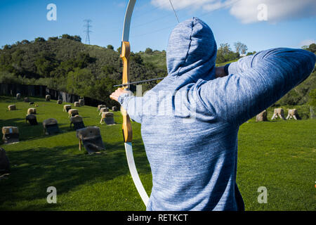 Unidentified person practicing archery; Stock Photo