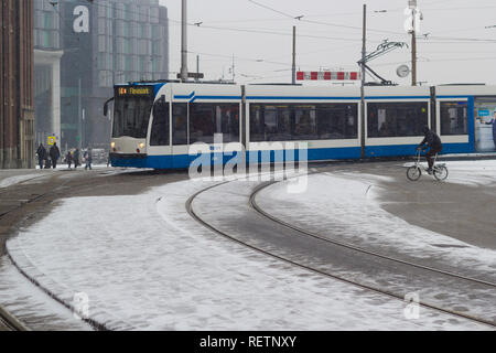 Amsterdam, the Netherlands - January 22 2019: GVB fast tram at Amsterdam central in snow view from above Stock Photo