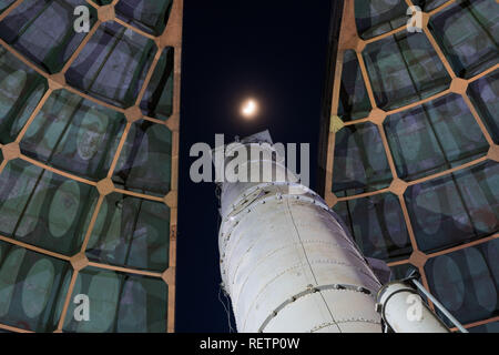 Old telescope looking towards the moon through the opened dome of an observatory Stock Photo