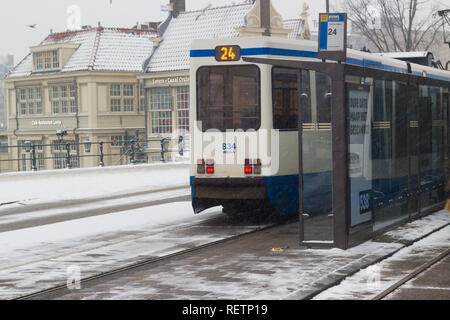 Amsterdam, the Netherlands - January 22 2019: GVB fast tram at Amsterdam central in snow view from above Stock Photo