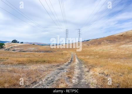 Walking trail among hills and valleys covered in dry grass, south San Francisco bay area, San Jose, California Stock Photo