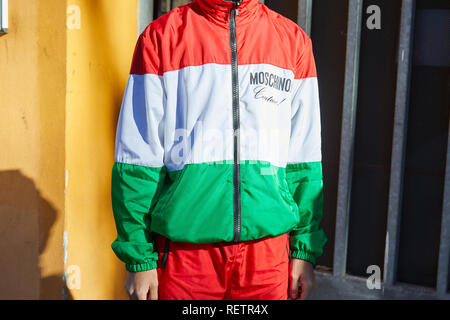 MILAN, ITALY - JANUARY 14, 2019: Man with Moschino suit with red, green and white Italian flag colors before Emporio Armani fashion show, Milan Fashio Stock Photo