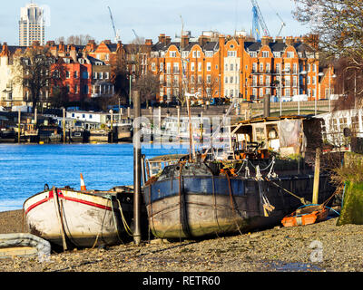 Boats moored at low tide on the Thames river in Wandsworth - South West London, England Stock Photo