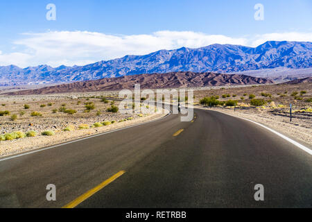 Driving through Death Valley National Park on clear morning, California Stock Photo