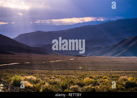 Filtered light illuminating Emigrant Canyon, Death Valley National Park, California Stock Photo