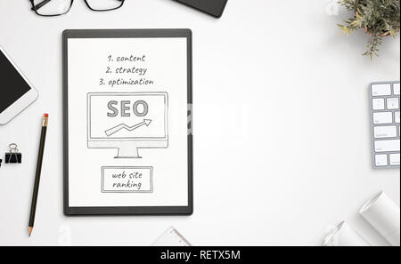Web site optimization for search engine goals  on paper. Top view, office desk composition with free space for text. Stock Photo