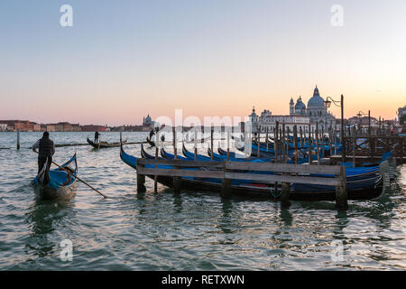 Venice, Italy - March 22, 2018: Gondola parking with Santa Maria della Salute at background in Venice, Italy Stock Photo
