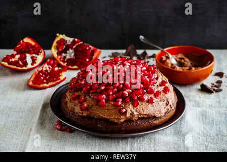 Homemade chocolate cake with fresh pomegranate and mascarpone cream Stock Photo