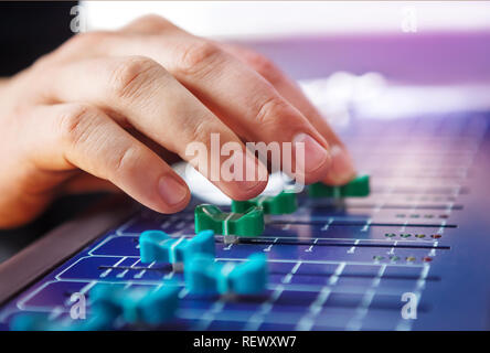 Professional audio engineer adjusting mixing concole. Stock Photo