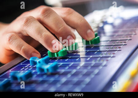 Professional audio engineer adjusting mixing concole. Stock Photo