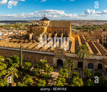 Panoramic aerial view of Moorish Mosque Cathedral (Mezquita) with tropical garden from Bell Tower in bright sunlight in Cordoba, Spain Stock Photo